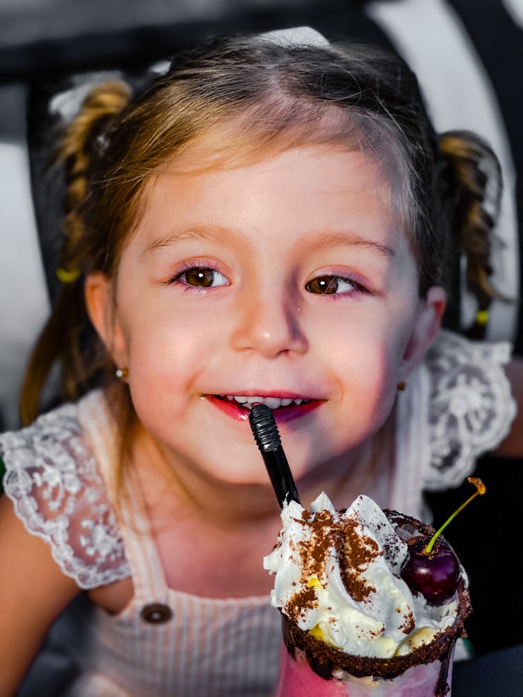 Little Girl Drinking A Shake