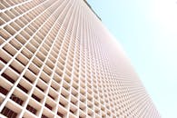 台北现代建筑的低角度视图展现了几何图案，同时阳光照射其中