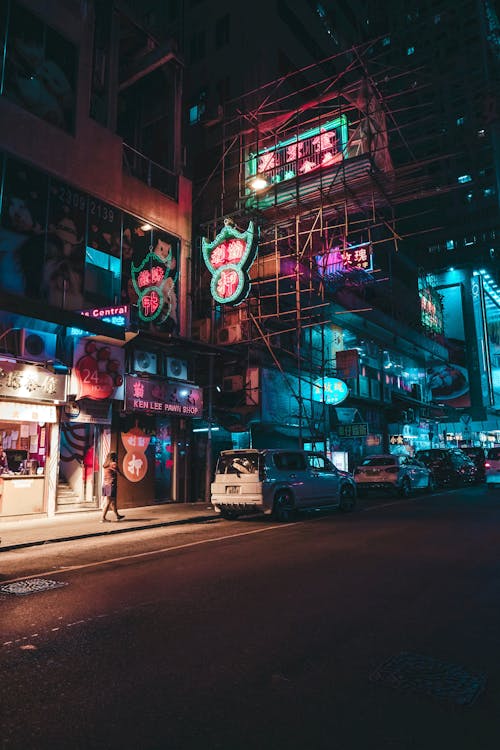 Free Photograph of Cars Parked Under Neon Signs Stock Photo