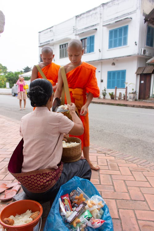 Woman and Monks on City Street