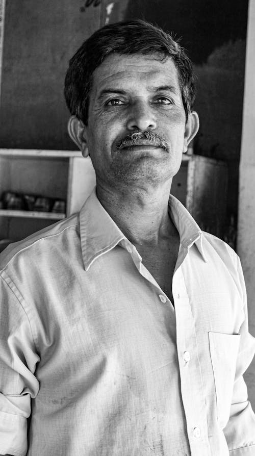 Grayscale Portrait of a Man in a Button-Up Shirt