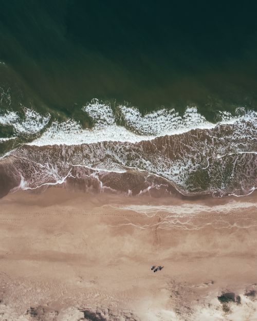 Free Stunning aerial view of the beach at Punta del Este in Uruguay, capturing the ocean waves and serene coastline. Stock Photo