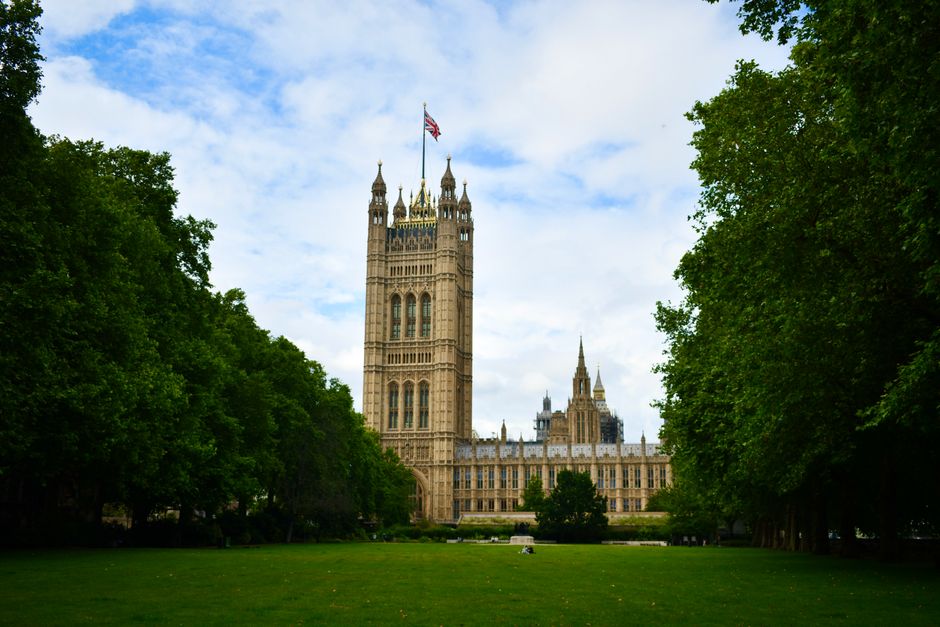 Stunning view of Victoria Tower with lush green surroundings in London, England, a historic and iconic landmark.