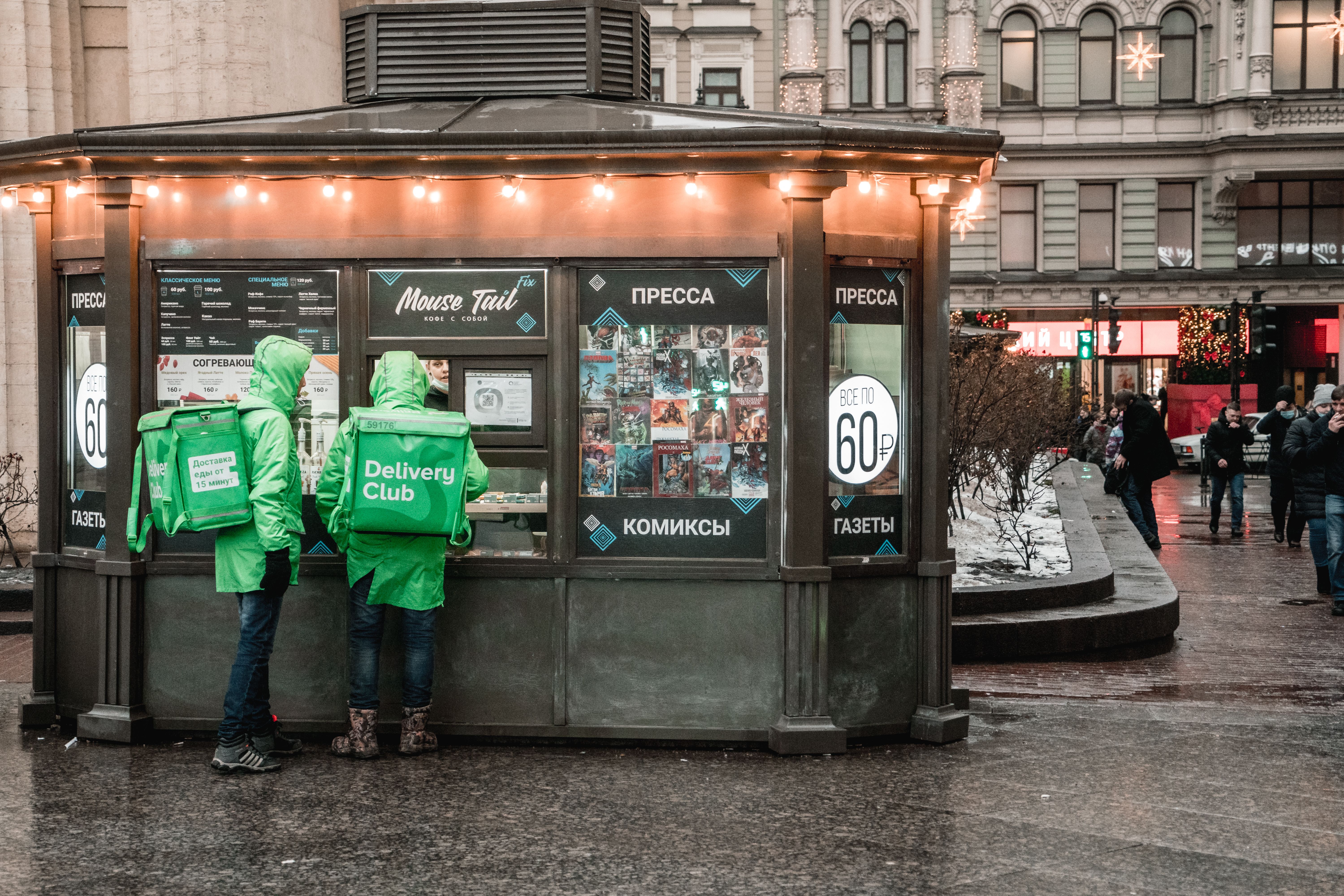 Deliveryman Standing In Front of a Food Stall · Free Stock Photo