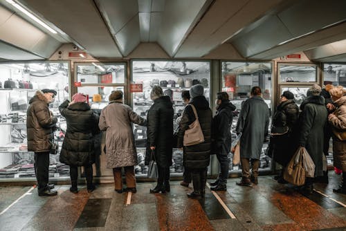 People Standing Near Display Window