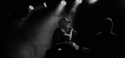 Monochrome Photo of Man Singing Live 