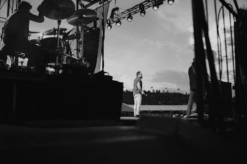 Grayscale Photo of Band Performing on Stage