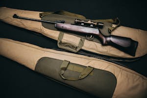 Black Rifle With Scope and Brown Gig Bag