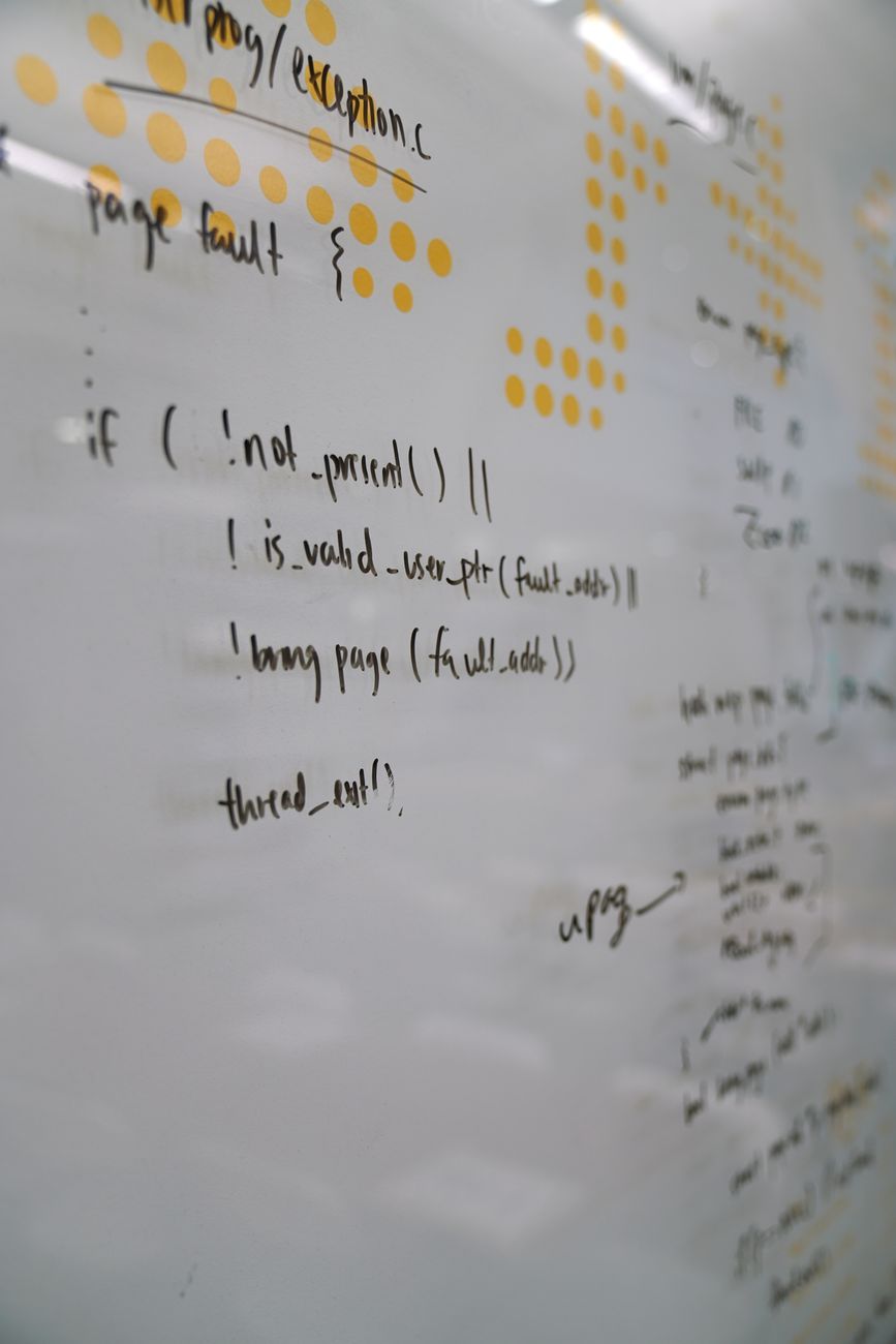 Software development team discussing architecture on a whiteboard