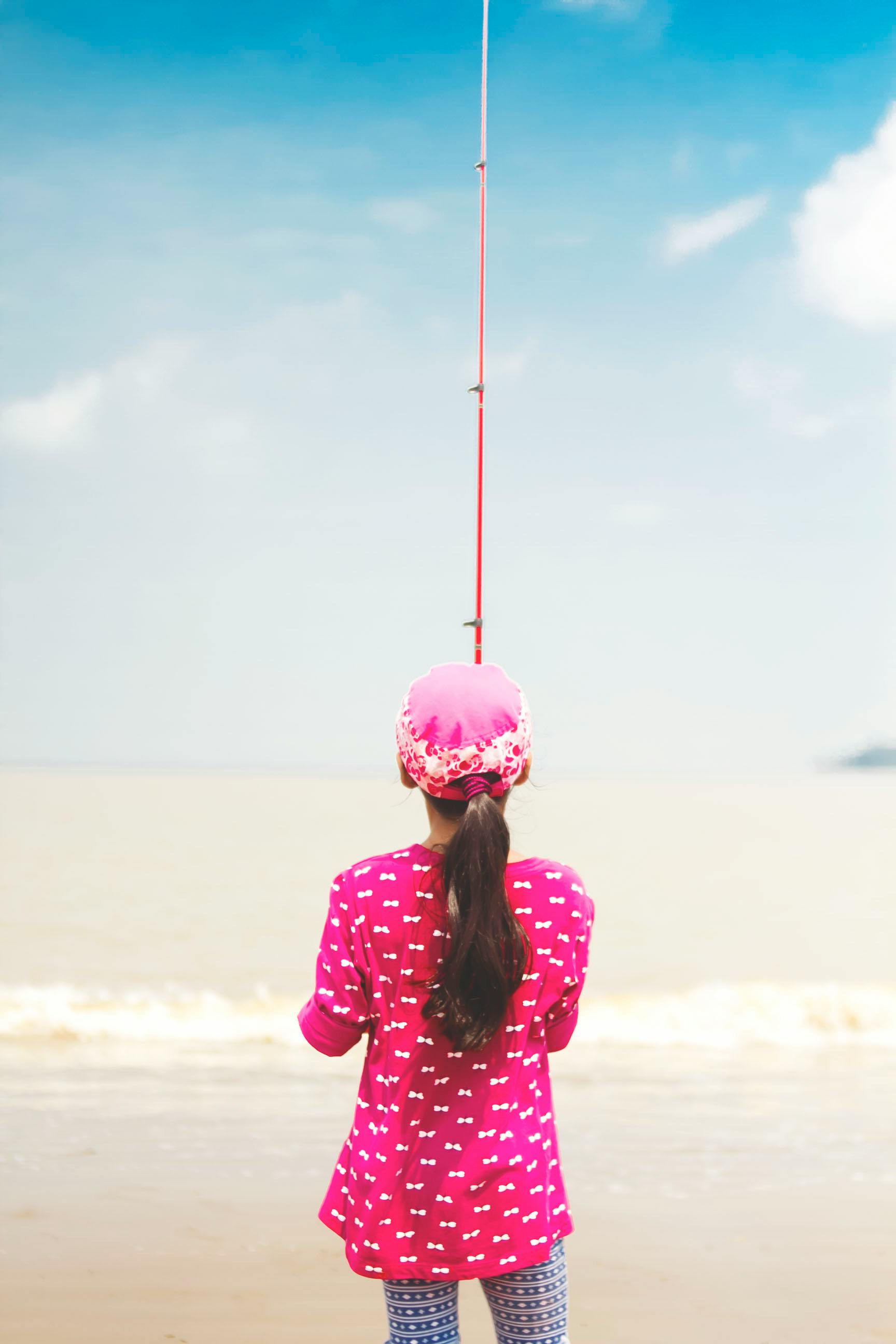 Woman in Pink Long-sleeved Shirt Holding Red Fishing Rod · Free