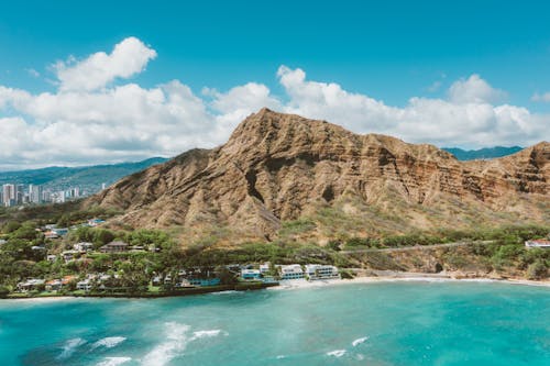 Blue Water and White Sand Beach by a Mountain