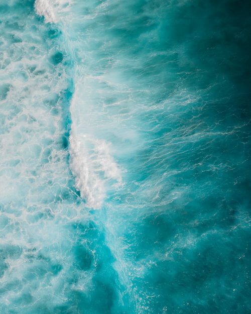 Free A breathtaking aerial view of turquoise ocean waves. Ideal for nature and travel themes. Stock Photo