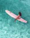 Woman in Black Bikini Top Holding White Surfboard in Water