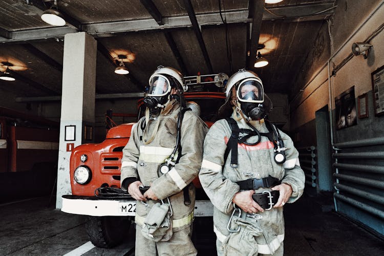 Firemen In Fire Uniforms And Tools