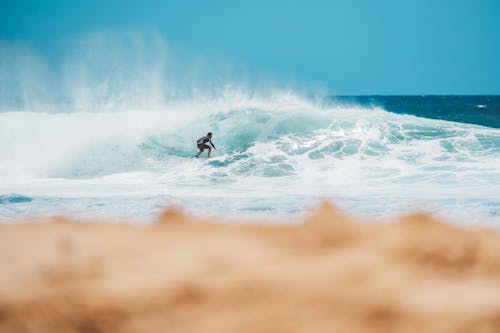 Person Surfing on Sea Waves