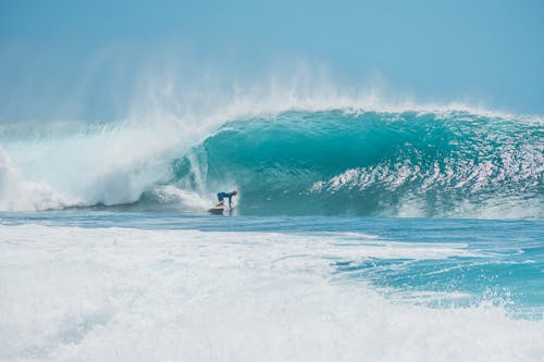 A Man Surfing in the Sea 