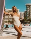 Woman in White and Black Stripe Spaghetti Strap Dress Standing on Beach