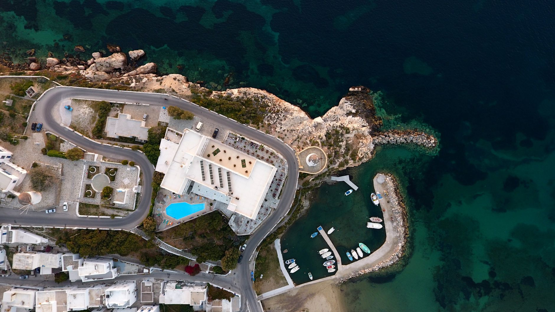 A stunning aerial perspective of Paros, Greece, showcasing its beautiful coastline, buildings, and harbor.