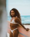 Woman in White Bikini Standing on Beach