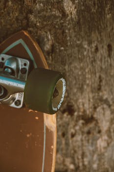 A detailed close-up of a vintage skateboard wheel against a rustic textured background.