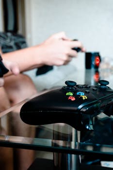 A close-up shot of an Xbox controller on a glass table during a gaming session.