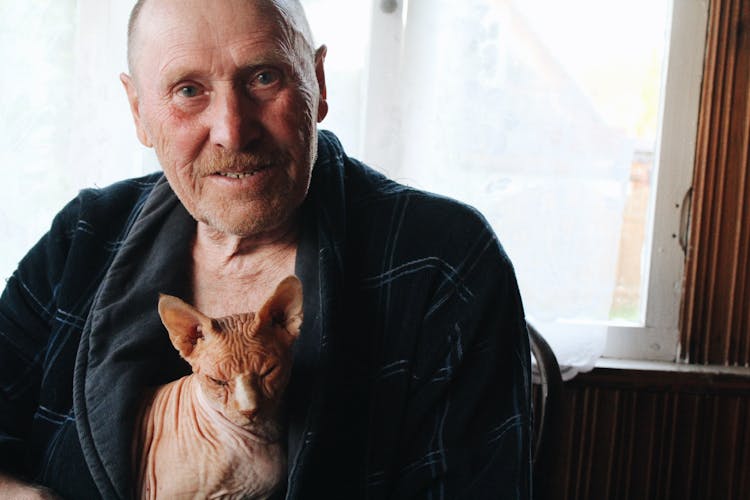 An Elderly Man Holding His Cat