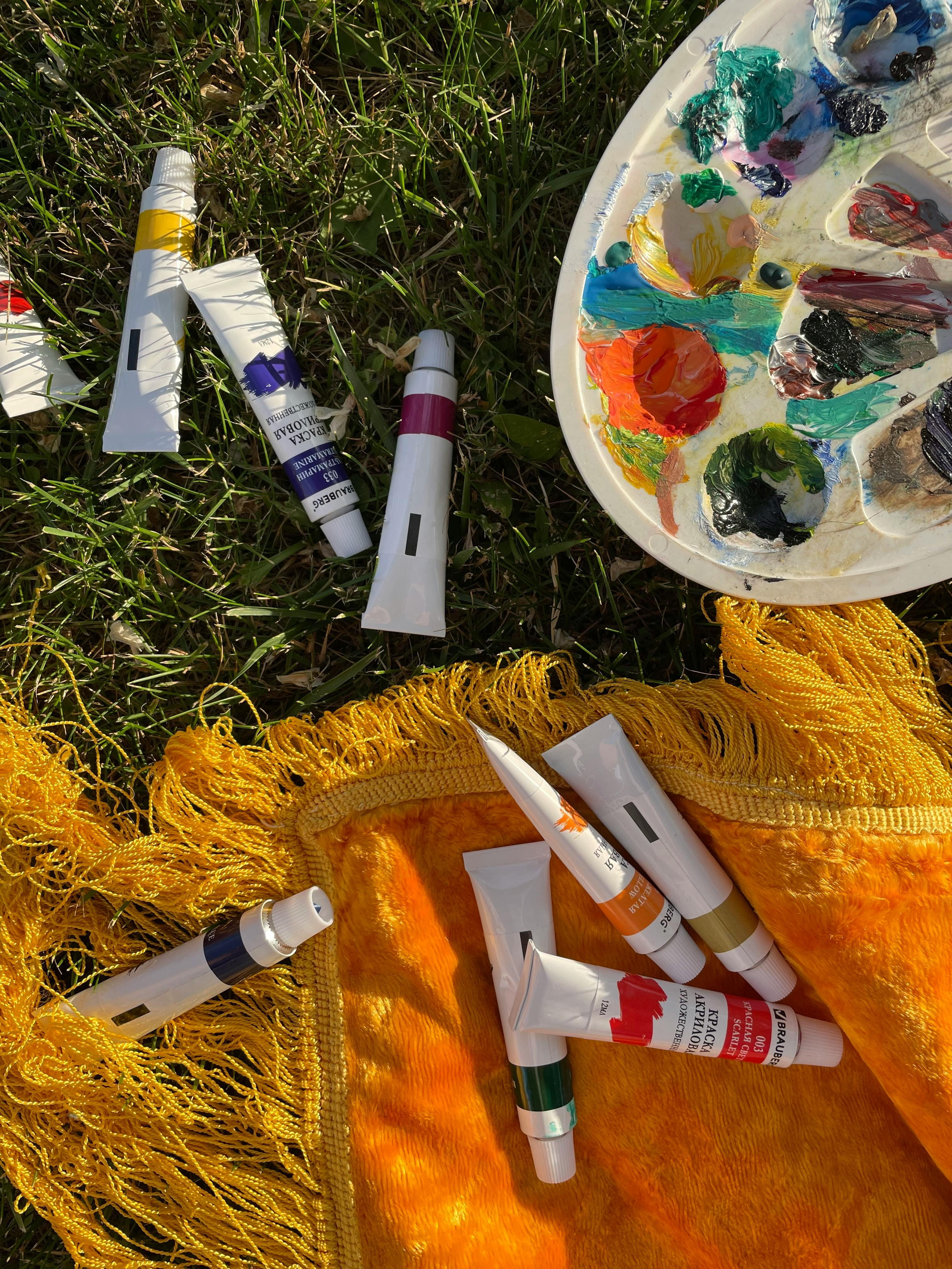 paint tubes and palette on grass