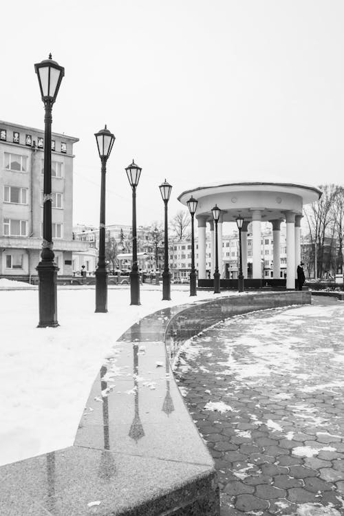 Monochrome Photograph of Street Lights During Winter