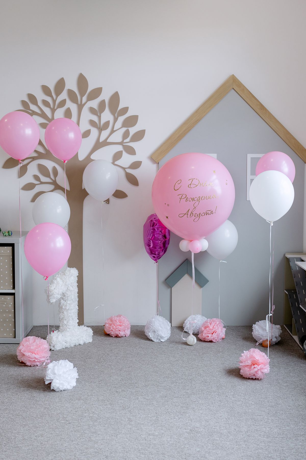 Pink and white birthday balloon decorations for a child’s celebration
