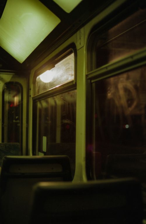 Free A dimly lit, empty tram interior at night with vintage vibes. Stock Photo