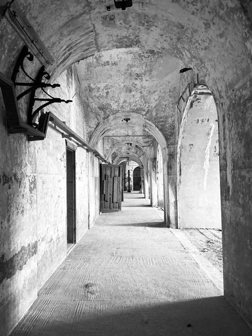 Free Explore the timeless beauty of an ancient stone corridor in stunning black and white. Stock Photo