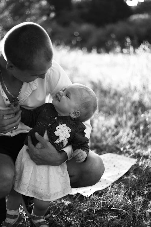 Free Grayscale Photo of a Man Carrying a Kid Stock Photo