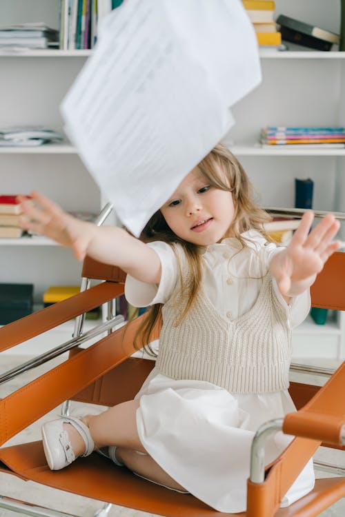 Free Photo of a Girl Throwing Sheets of Paper Stock Photo