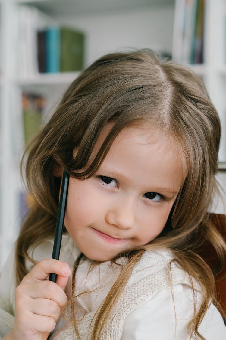 Portrait Of A Child Holding A Black Pencil