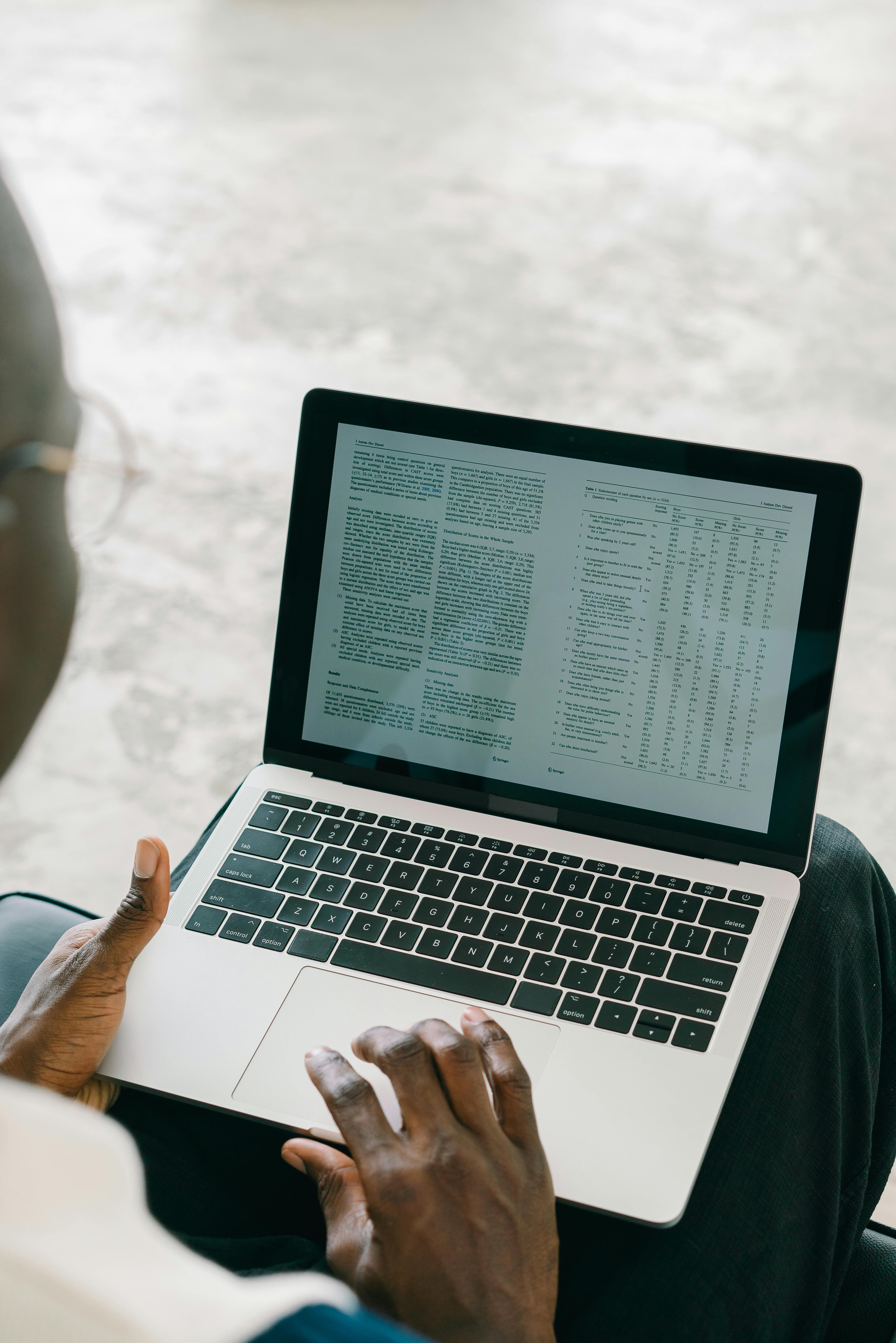 Close-up of a person using a laptop with spreadsheets and text on the screen. - My Step-by-Step: How I Reset My SEO to Fix Fiverr Gig 0 Impressions.