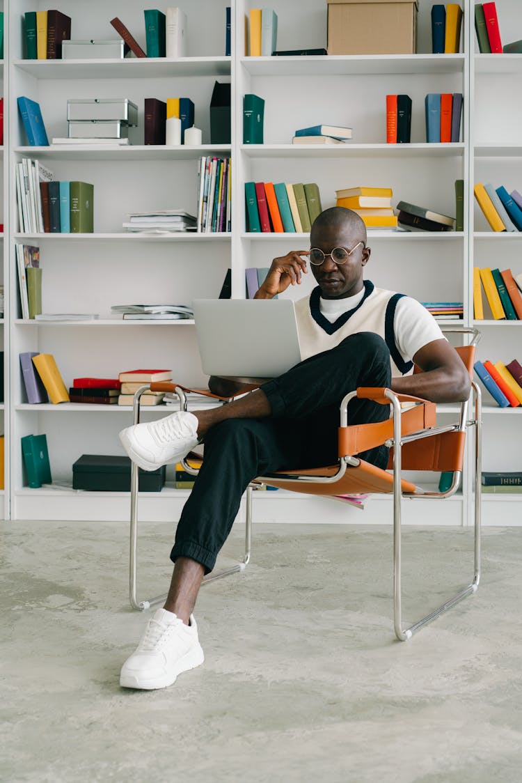 Man With A Laptop Sitting On A Chair