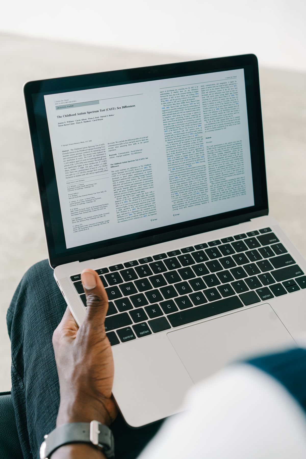 Person browsing and researching different loan options on a laptop