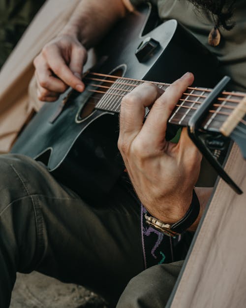 Free Close-Up Shot of a Person Playing Acoustic Guitar Stock Photo