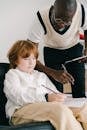 Woman in White Long Sleeve Shirt Holding a Girl in White Long Sleeve Shirt