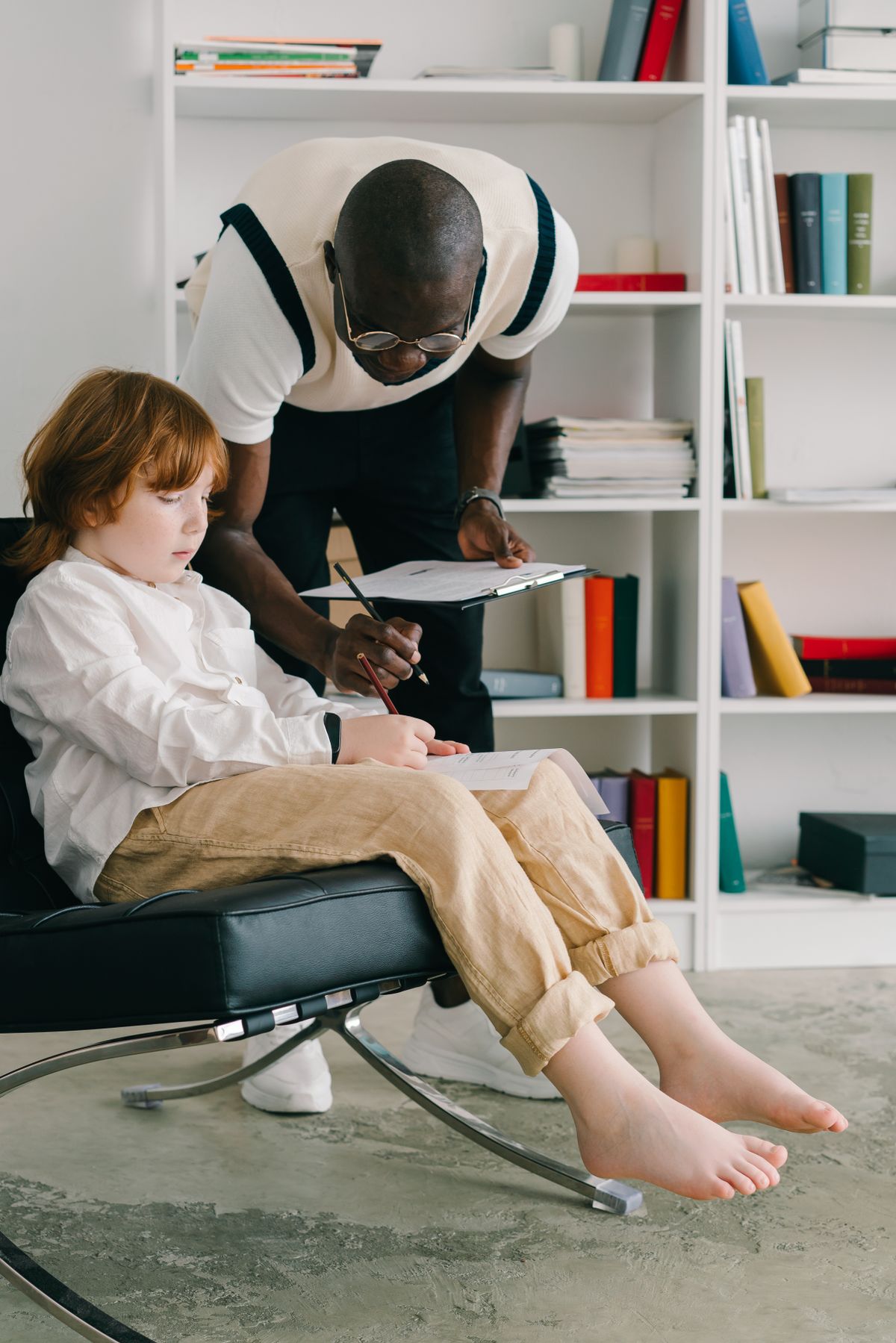 Behavior technician helping a child with a learning activity