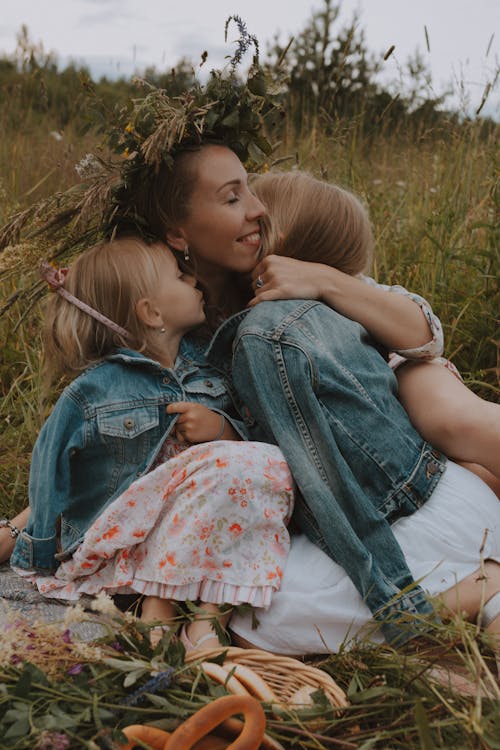 A Woman Embracing her Daughters