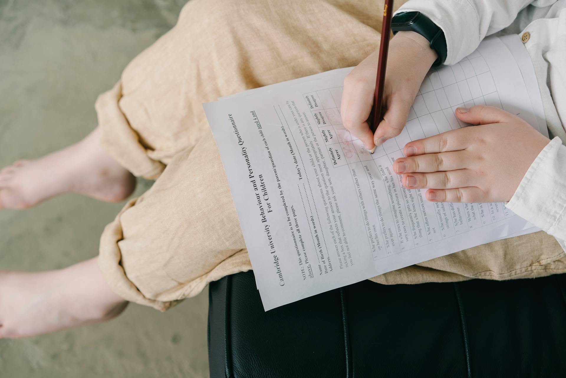 Child Filling Questionnaire in with Pencil