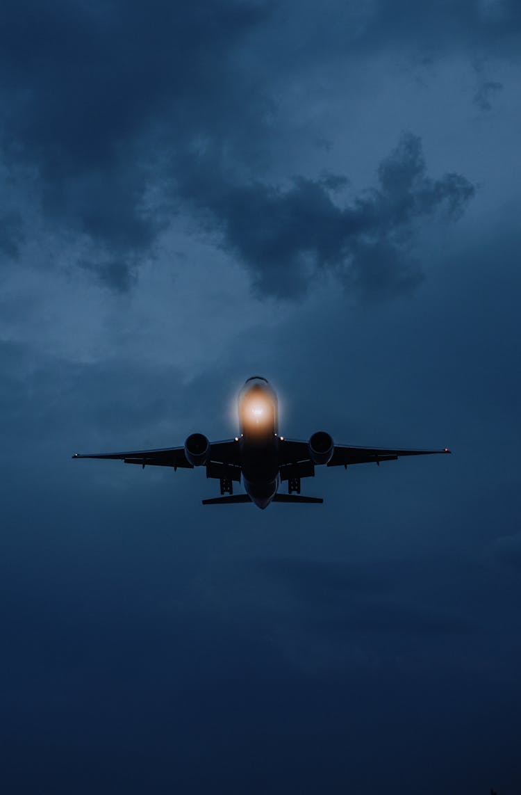 An Airplane Flying At Night