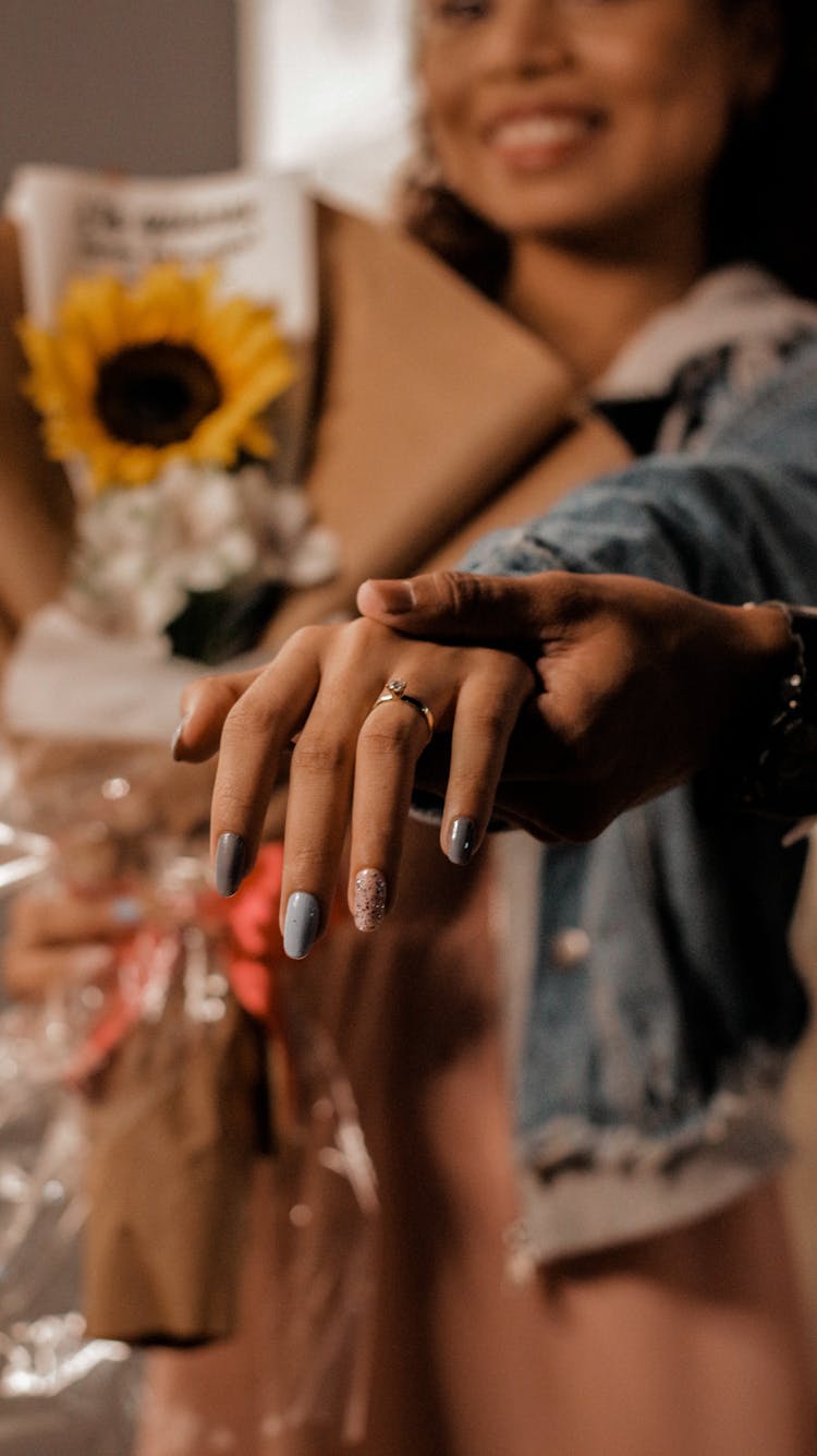 Photo Of A Woman's Hand With An Engagement Ring