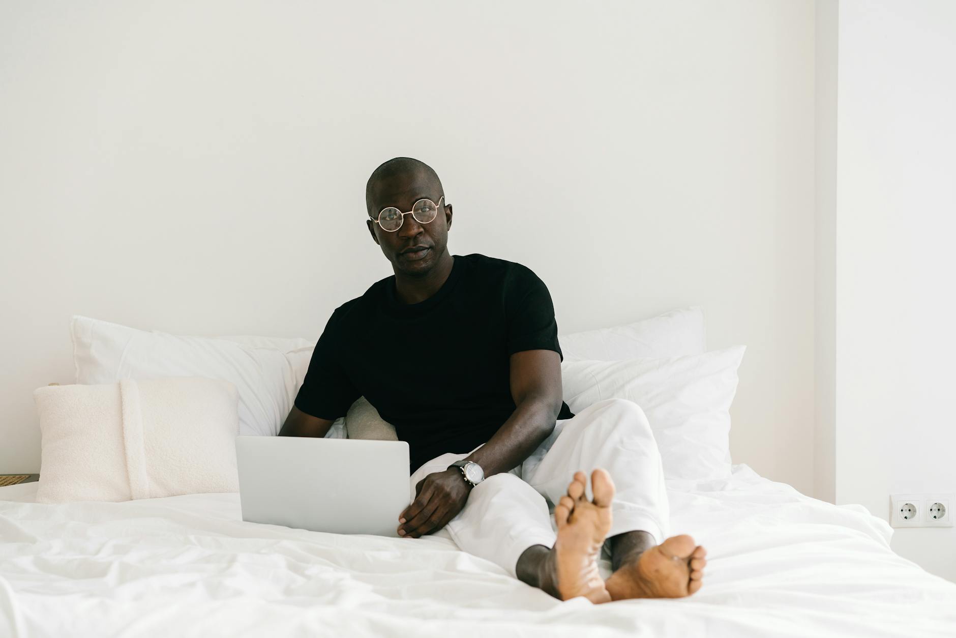https://www.pexels.com/photo/man-in-black-crew-neck-t-shirt-sitting-on-bed-8654707/