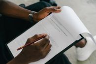 Person Writing on White Paper