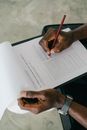 Person Writing on White Paper