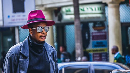 Man Wearing Purple Hat and Black Leather Jacket