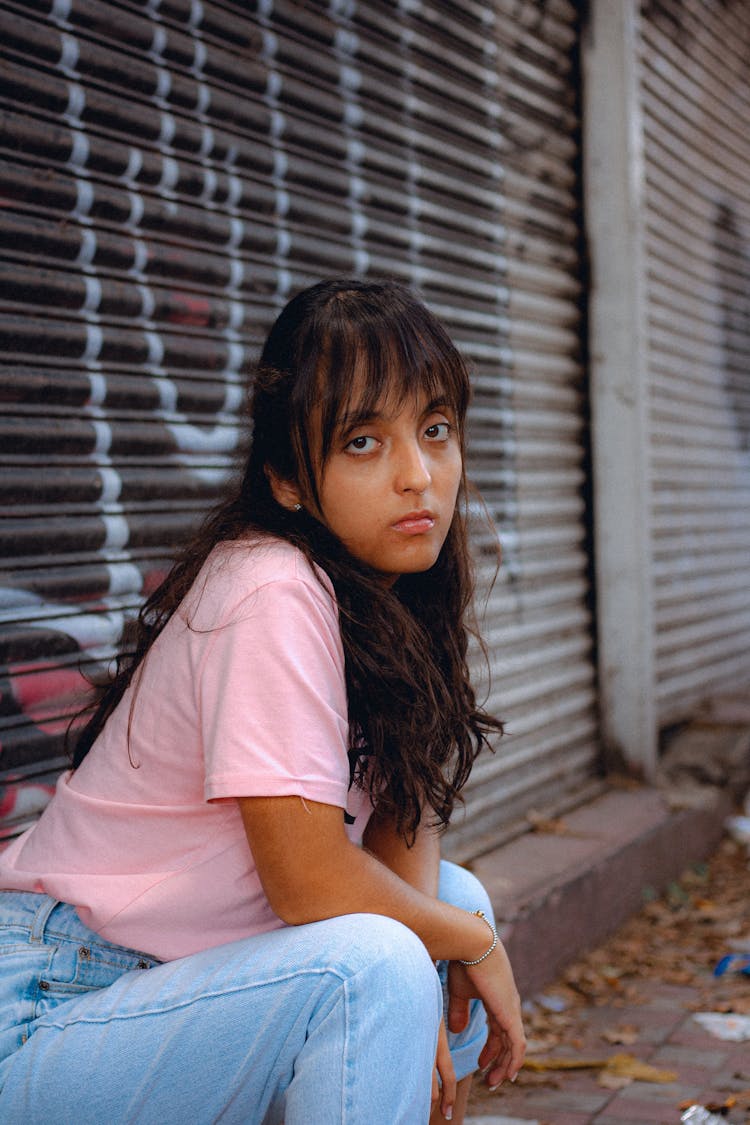 Woman In Denim Pants And Pink T Shirt Posing