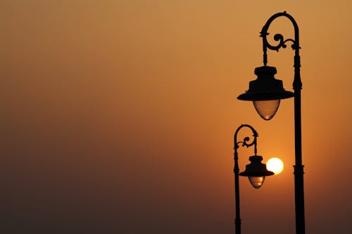 A Silhouette of Street Lamps During the Golden Hour